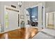 Inviting foyer with hardwood floors, white trim, and view into the dining room at 10501 Olde Irongate Ln, Mint Hill, NC 28227
