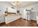 Kitchen with white cabinetry, wood flooring, stainless refrigerator, and granite countertops at 10501 Olde Irongate Ln, Mint Hill, NC 28227