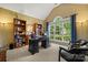 Bright home office with built-in bookshelves, large window, and vaulted ceilings at 10501 Olde Irongate Ln, Mint Hill, NC 28227