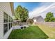 Beautifully landscaped backyard with a lush lawn, a concrete patio, and a privacy fence at 107 Golden Valley Dr, Mooresville, NC 28115
