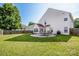 Spacious backyard featuring a well-manicured lawn, a patio with outdoor furniture, and a privacy fence at 107 Golden Valley Dr, Mooresville, NC 28115