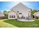Spacious backyard featuring a well-maintained lawn and a concrete patio with outdoor seating at 107 Golden Valley Dr, Mooresville, NC 28115