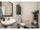 Charming powder room featuring a pedestal sink, decorative mirror, and stylish storage cabinet at 107 Golden Valley Dr, Mooresville, NC 28115