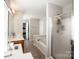 Bright primary bath with tub, glass shower, neutral colors, and and vanities at 107 Golden Valley Dr, Mooresville, NC 28115