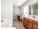Primary bathroom with dual sinks, soaking tub, and separate shower with abundant counter space and storage at 107 Golden Valley Dr, Mooresville, NC 28115