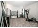 Minimalist bedroom provides space for essential furniture and workout equipment at 107 Golden Valley Dr, Mooresville, NC 28115