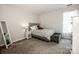 Cozy bedroom features a tufted headboard, soft gray tones, and accent furniture, perfect for unwinding at 107 Golden Valley Dr, Mooresville, NC 28115