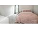 Comfortable bedroom with soft, pink accents and neutral walls provides a calming atmosphere at 107 Golden Valley Dr, Mooresville, NC 28115