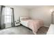 Serene bedroom with a large window, a plush bed, and soft, neutral tones for relaxation at 107 Golden Valley Dr, Mooresville, NC 28115