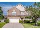 Two-story brick and vinyl home featuring manicured landscaping, a two-car garage and a welcoming front porch at 107 Golden Valley Dr, Mooresville, NC 28115