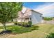 Back yard view of this 2-story home, featuring a mix of brick and vinyl siding and an immaculate lawn at 107 Golden Valley Dr, Mooresville, NC 28115