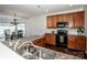 Well-appointed kitchen with stainless steel appliances, dark hardwood floors and light wood cabinets at 107 Golden Valley Dr, Mooresville, NC 28115