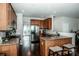 Bright kitchen offers granite counters, stainless steel appliances, hardwood floors, and a door to the backyard at 107 Golden Valley Dr, Mooresville, NC 28115