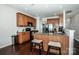 Well-lit kitchen featuring granite countertops, stainless appliances, and a stylish breakfast bar with stool seating at 107 Golden Valley Dr, Mooresville, NC 28115