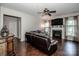 Well lit living room with an electric fireplace, large windows and dark hardwood floors at 107 Golden Valley Dr, Mooresville, NC 28115