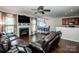 Spacious living room featuring a fireplace, ceiling fan and seamless access to a dining area at 107 Golden Valley Dr, Mooresville, NC 28115