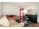 Spacious living room featuring cozy seating and unique salon setup with professional chair at 107 Golden Valley Dr, Mooresville, NC 28115