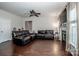 Large living room with dark hardwood floors, an electric fireplace and a stylish ceiling fan at 107 Golden Valley Dr, Mooresville, NC 28115