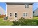 Backyard featuring a well maintained lawn, an air conditioning unit, and a door to the home at 108 Greenway View Ct, Mount Holly, NC 28120
