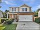 Charming two-story home featuring a brick facade, a two-car garage, and a well-manicured lawn at 108 Greenway View Ct, Mount Holly, NC 28120