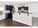 Kitchen featuring dark wood cabinets, granite countertops, and hardwood floors at 108 Greenway View Ct, Mount Holly, NC 28120