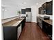 Modern kitchen with stainless steel appliances, dark cabinetry, and granite countertops at 108 Greenway View Ct, Mount Holly, NC 28120