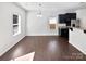 Open-concept living room with hardwood floors and abundant natural light from bright windows at 108 Greenway View Ct, Mount Holly, NC 28120