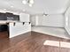 Bright open-concept kitchen flows into living room with modern finishes and natural light at 108 Greenway View Ct, Mount Holly, NC 28120