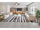 Bright living room featuring stylish furniture, a striped rug, and a ceiling fan at 108 Greenway View Ct, Mount Holly, NC 28120