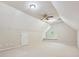 Finished attic featuring neutral carpet, a ceiling fan and a unique round window at 12029 Forest Home Dr, Fort Mill, SC 29708