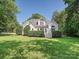 Well-maintained white home exterior with lush landscaping and a walkout deck at 12029 Forest Home Dr, Fort Mill, SC 29708