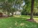 Sprawling backyard with mature trees providing ample shade and privacy at 12029 Forest Home Dr, Fort Mill, SC 29708
