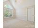 Bright bedroom with a large arch window and neutral carpeting at 12029 Forest Home Dr, Fort Mill, SC 29708