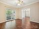 Spacious bedroom featuring hardwood floors, light-colored walls, and an adjoining sitting room at 12029 Forest Home Dr, Fort Mill, SC 29708