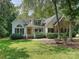 Charming home with a manicured lawn, brick accents and a welcoming front porch lined with manicured shrubs at 12029 Forest Home Dr, Fort Mill, SC 29708