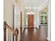 Bright foyer with hardwood floors, chandelier and a view of the front yard through a large window at 12029 Forest Home Dr, Fort Mill, SC 29708