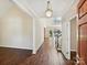 Elegant foyer with gleaming hardwood floors, a chandelier, and a staircase at 12029 Forest Home Dr, Fort Mill, SC 29708