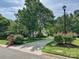 Inviting home with a long driveway framed by mature trees and flowering shrubs at 12029 Forest Home Dr, Fort Mill, SC 29708