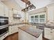 Well-lit kitchen with custom cabinets, granite countertops, stainless appliances, and an island at 12029 Forest Home Dr, Fort Mill, SC 29708