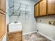 Functional laundry room with built-in shelving and sink offering utility and storage at 12029 Forest Home Dr, Fort Mill, SC 29708