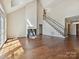 Open concept living area with hardwood floors, fireplace, and stairs to upper level at 12029 Forest Home Dr, Fort Mill, SC 29708