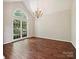 Spacious living room featuring a large window, hardwood floors, chandelier and vaulted ceilings at 12029 Forest Home Dr, Fort Mill, SC 29708