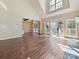 Living room with hardwood floors, natural light, and slider doors leading to outdoor deck at 12029 Forest Home Dr, Fort Mill, SC 29708