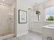 Bright bathroom featuring a glass shower, modern fixtures, and gray tiled floor at 123 Armstrong Rd, Belmont, NC 28012