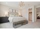 Neutral bedroom with a unique bench at the end of the bed and a walk in closet at 123 Armstrong Rd, Belmont, NC 28012