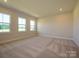 Spacious, carpeted bedroom with ample natural light from large windows at 123 Armstrong Rd, Belmont, NC 28012