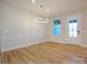Dining room features a modern chandelier, large windows and a door leading outside at 123 Armstrong Rd, Belmont, NC 28012