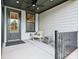 Cozy front porch featuring a chair, small table, and a stylish door at 123 Armstrong Rd, Belmont, NC 28012