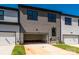 View of townhome garage with dark trim and ample parking space at 123 Armstrong Rd, Belmont, NC 28012