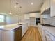 Bright and modern kitchen with stainless steel appliances, white cabinets, and an island with sink at 123 Armstrong Rd, Belmont, NC 28012